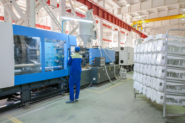 man operating a large machine in a workshop