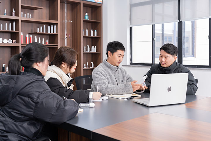 four people discussing on a large table