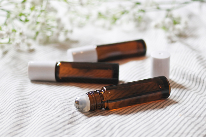three amber-colored vials with white covers
