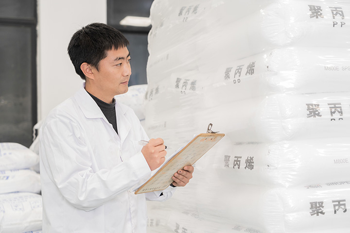 man holding a clipboard checking the incoming materials