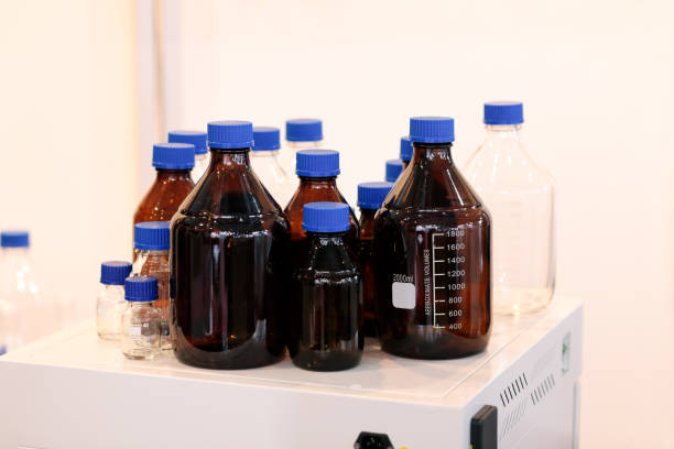 Empty glass reagent bottles in chemical laboratory. Selective focus.