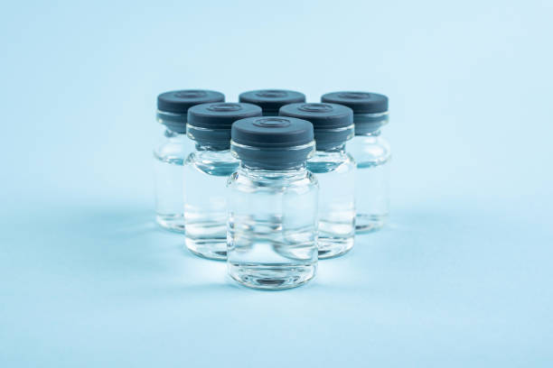 Vaccine and syringe on blue background